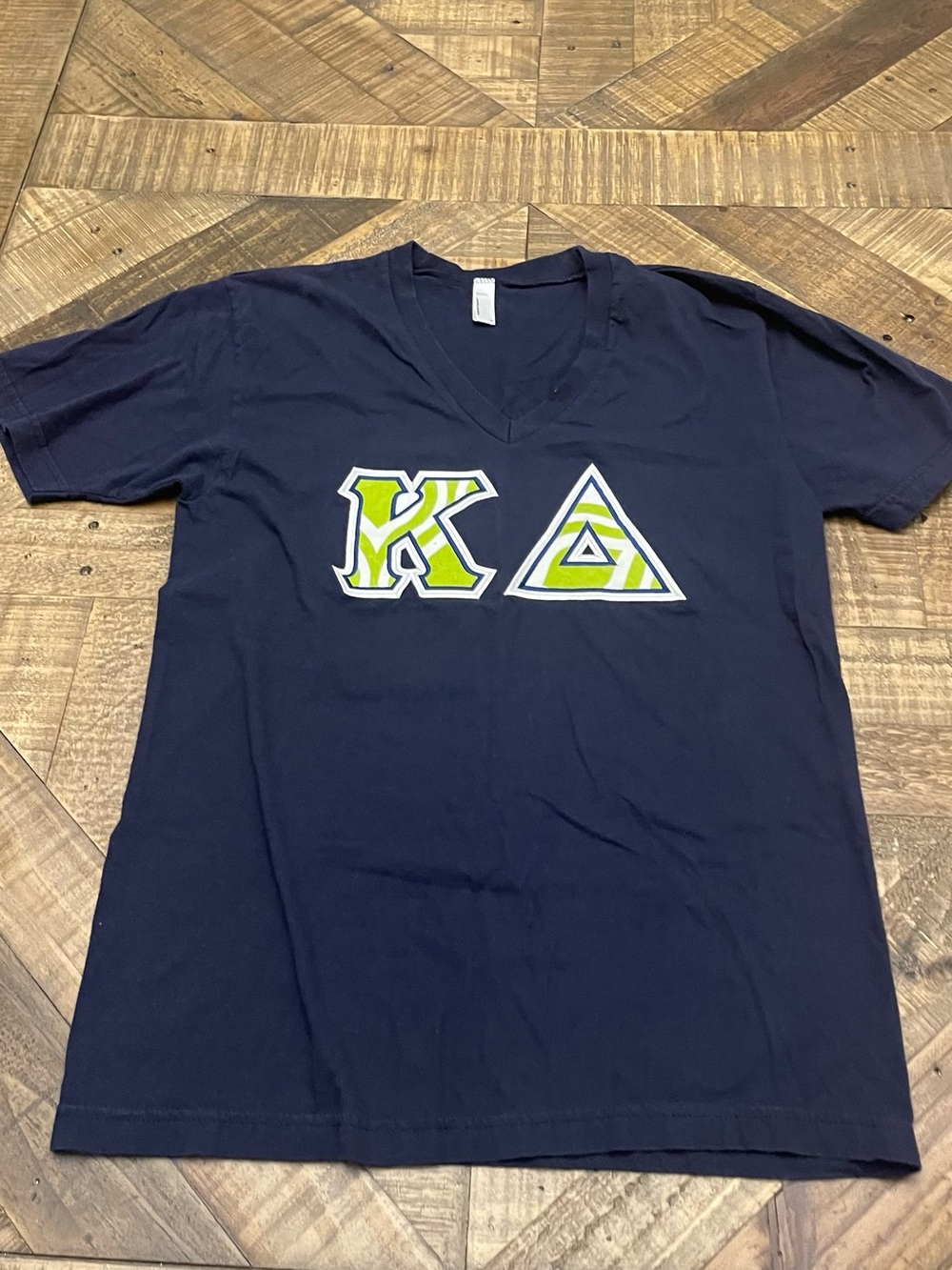 navy blue V-neck Kappa Delta t-shirt features custom sewn-on Greek letters